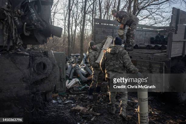Members of a Ukrainian artillery unit, reload equipment and ammunition into a M109 self propelled artillery unit before moving to a location to fire...