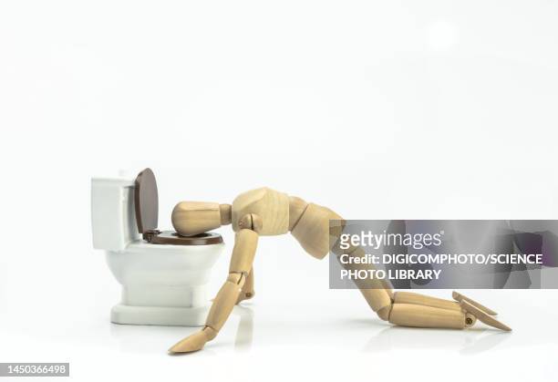 wooden doll vomiting in a toilet, conceptual image - vomiting stock pictures, royalty-free photos & images