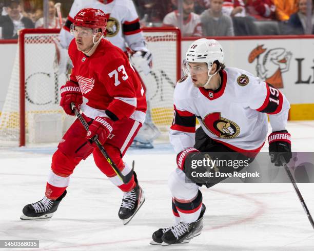 Drake Batherson of the Ottawa Senators turns up ice next to Adam Erne of the Detroit Red Wings during the second period of an NHL game at Little...