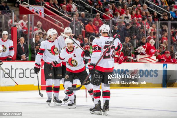 Claude Giroux of the Ottawa Senators celebrates an open net goal with teammates during the third period of an NHL game against the Detroit Red Wings...