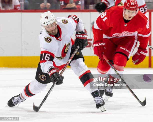 Austin Watson of the Ottawa Senators clears the puck against the Detroit Red Wings during the second period of an NHL game at Little Caesars Arena on...