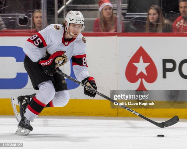 Jake Sanderson of the Ottawa Senators skates up ice with the puck against the Detroit Red Wings during the second period of an NHL game at Little...