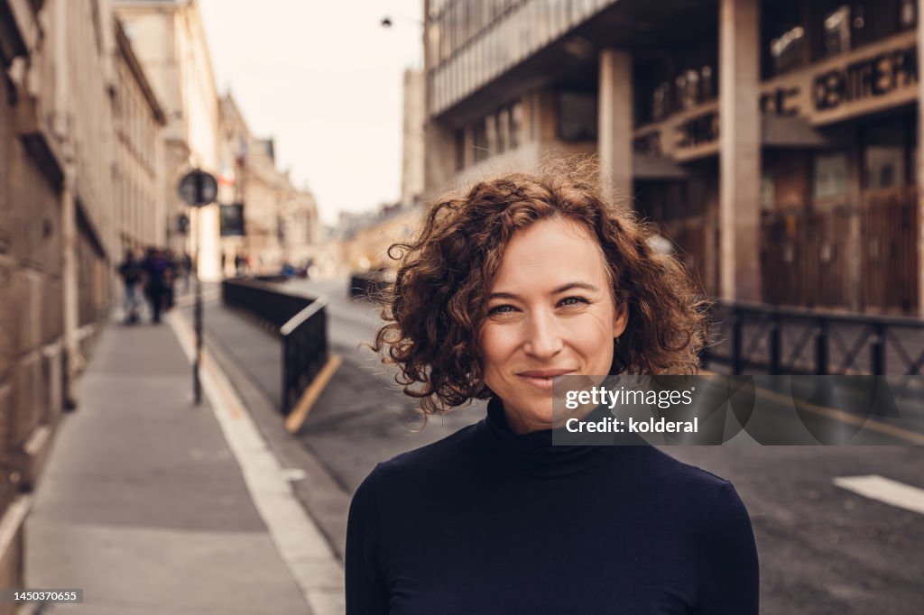 Portrait of smiling woman on the street in Paris