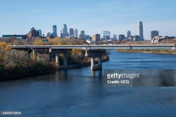Minneapolis, Minnesota, City skyline with the I-94 steel girder Dartmouth bridge that spans the Mississippi River .