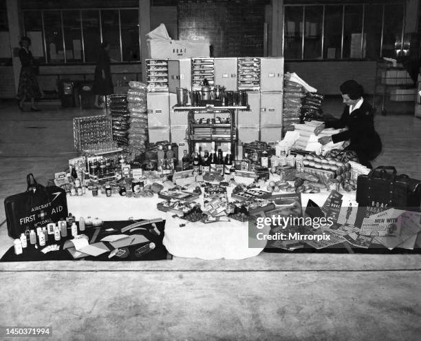 Air Hostess Daphne Webster, of Hillingdon, Middlesex sitting amongst over 2,000 items ranging from coat hangers to grape scissors, from toothbrushes...