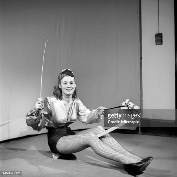Woman wearing fancy dress jockey outfit. Circa 1959.