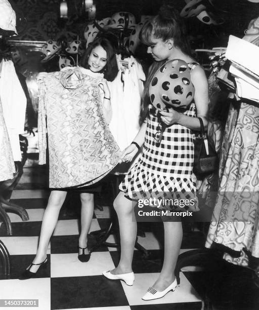 Russian girls trying out clothes in the archetypal London shop, Biba Boutique, Kensington Church Street, London. 25th July 1958.