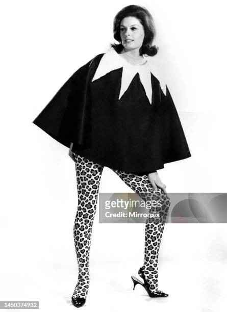 Gloria James wearing a cape that can double up as a skirt. Gloria is also wearing animal print tights. January 1965.