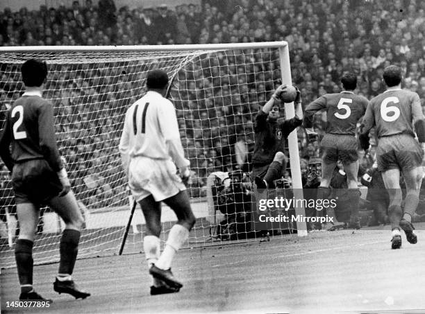Cup Final at Wembley Stadium. Leeds 1 v Liverpool 2. Liverpool goalkeeper Tommy Lawrence holds on to the ball watched by his defenders. May 1965.