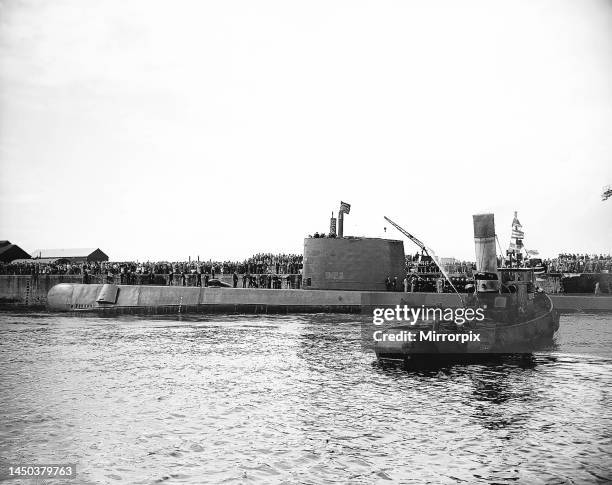 The submarine Nautilus which became the first submarine to sail under the polar ice caps is escorted into Weymouth Harbour where it was greeted by...