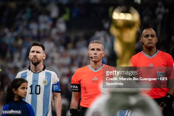 Lionel Messi of Argentina looks on in front of the World Cup trophy prior to the FIFA World Cup Qatar 2022 Final match between Argentina and France...