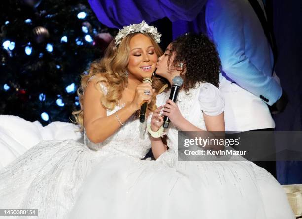 In this image released on December 19, Mariah Carey performs onstage with Monroe Cannon during her "Merry Christmas To All!" at Madison Square Garden...