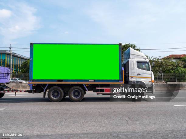 close up of truck lorry haulage vehicle on highway with green screen chroma key marketing advertisement billboard on side that can be replaced with marketing or ad agencies campaign content targeting adverts at consumers, retail shoppers, commuters - billboard blank stock pictures, royalty-free photos & images