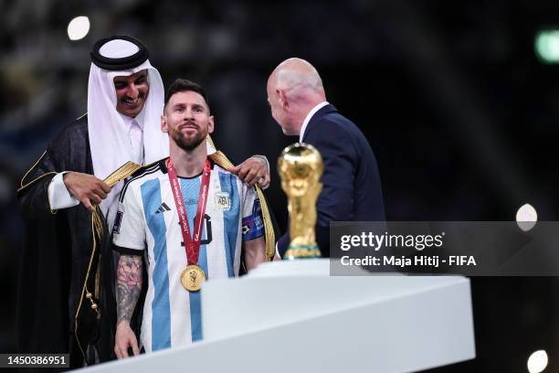 Lionel Messi of Argentina is presented with a traditional robe by Sheikh Tamim bin Hamad Al Thani, Emir of Qatar, during the awards ceremony after...