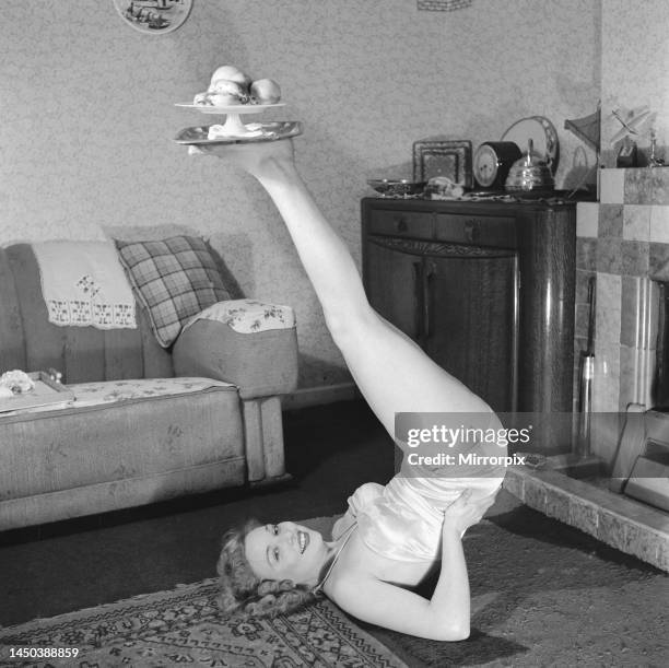 Teenager Maureen Mulcock of Bellingham, South East London, balances a platter of fruit on the bottom of her feet as he tries to keep fit in...