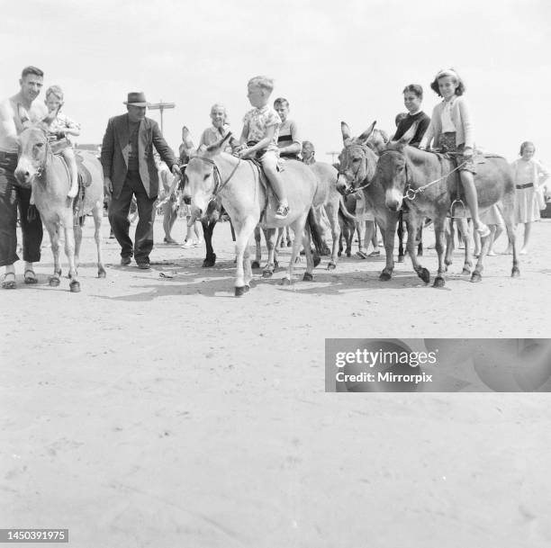 Children ride donkeys in Bognor Regis. 1st August 1959.