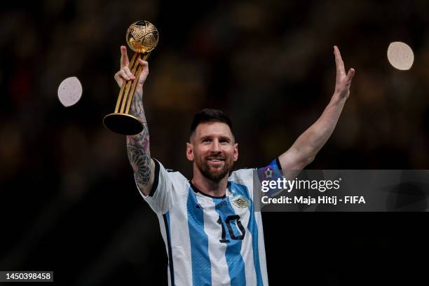 Lionel Messi of Argentina reacts as he holds the adidas Golden Boot award after the FIFA World Cup Qatar 2022 Final match between Argentina and...