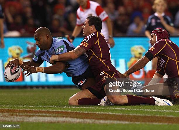 Akuila Uate of the Blues scores a try during game one of the ARL State of Origin series between the Queensland Maroons and the New South Wales Blues...