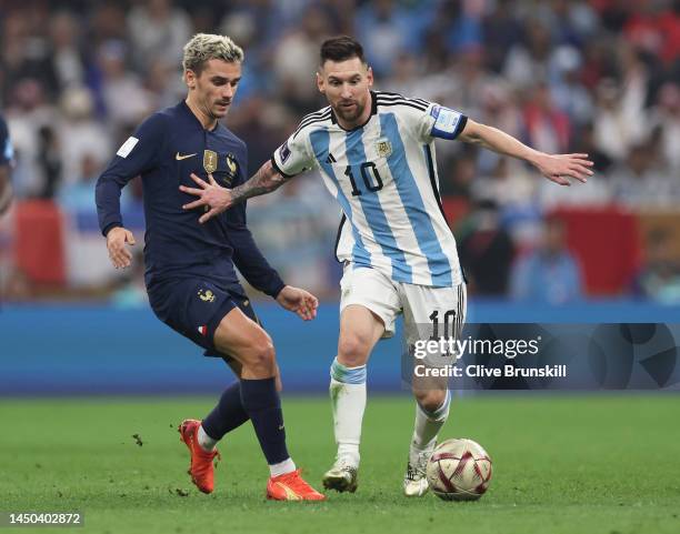 Lionel Messi of Argentina under pressure from Antoine Griezmann of France during the FIFA World Cup Qatar 2022 Final match between Argentina and...