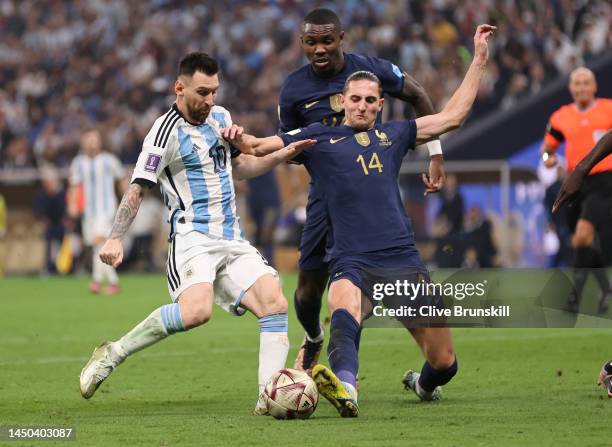 Lionel Messi of Argentina attempts to shoot at goal whilst challenged by Adrien Rabiot of France during the FIFA World Cup Qatar 2022 Final match...