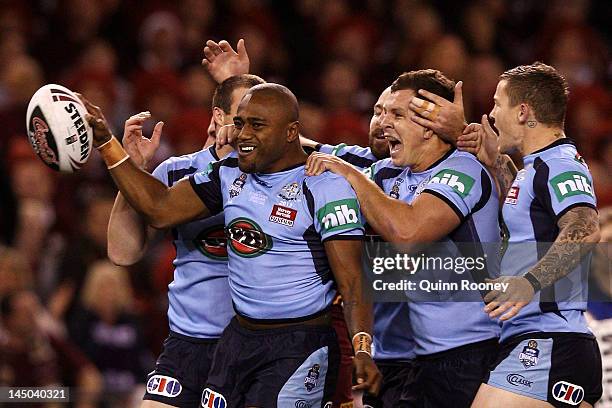 Akuila Uate of the Blues celebrates with team mates after scoring the opening try during game one of the ARL State of Origin series between the...