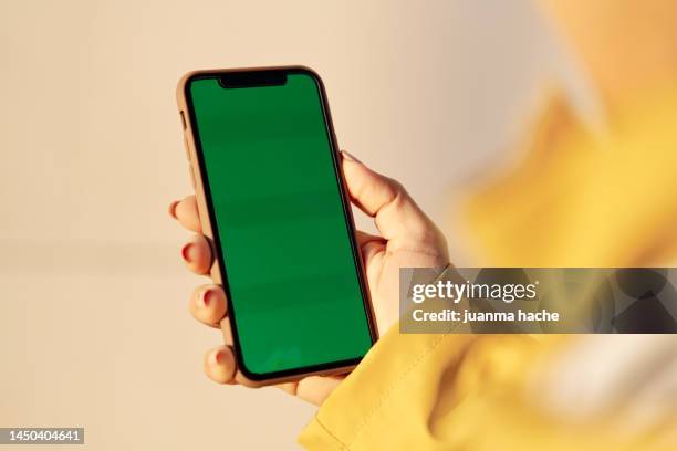 crop woman using smartphone with blank screen - marcare foto e immagini stock