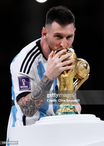 Adidas Golden Ball winner Lionel Messi of Argentina kisses the FIFA World Cup Winners The FIFA World Cup Qatar 2022 Winner's Trophy at the award...