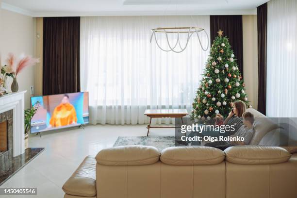 television program for whole family. family watching tv series and movies at home on christmas eve - family tv pet stock pictures, royalty-free photos & images