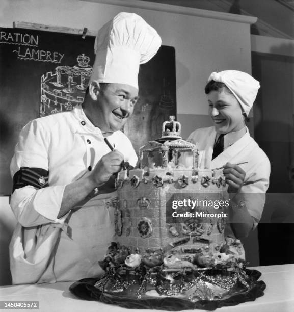 Cooks decorate a Coronation Lamprey Cake for the Queens Coronation. May 1953.