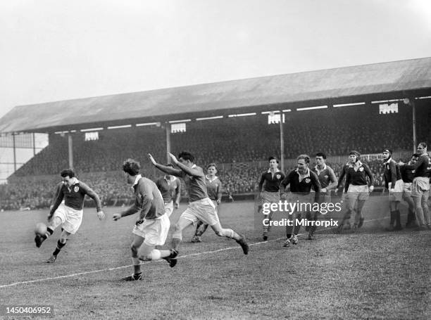 Action from the 1953 Five Nations Match between Wales and Ireland at the St Helens Ground Swansea. Jackie Kyle seen here on the attack for Ireland...