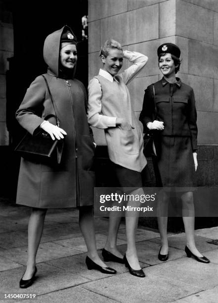 Three of the models in the new bright red hooded coat zipped up to the neck, a Pinafore dress as to be worn by air stewardesses, and passenger...
