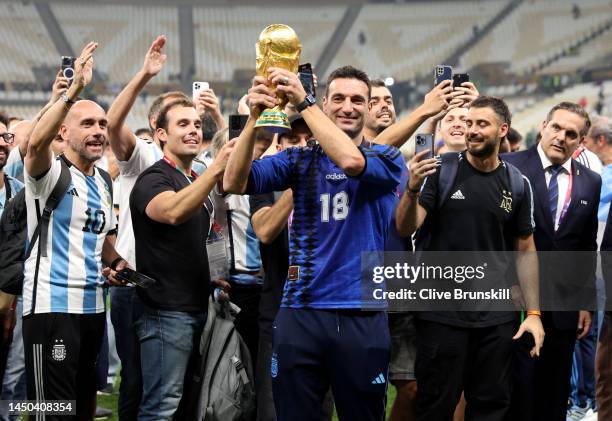 Lionel Scaloni, Head Coach of Argentina celebrates with his team and friends with the FIFA World Cup Qatar 2022 Winner's Trophy after the team's...