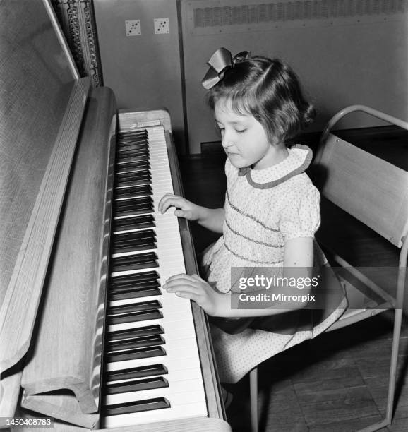 Six and a half year old Elizabeth Bick, a talented young pianist performing for her friends. May 1953.