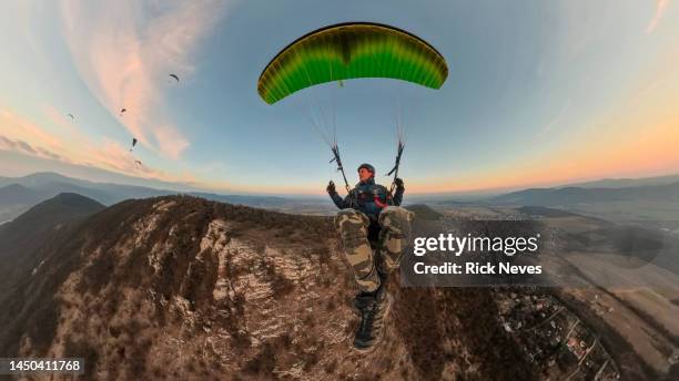 man flying the paragliding - パラシュート ストックフォトと画像