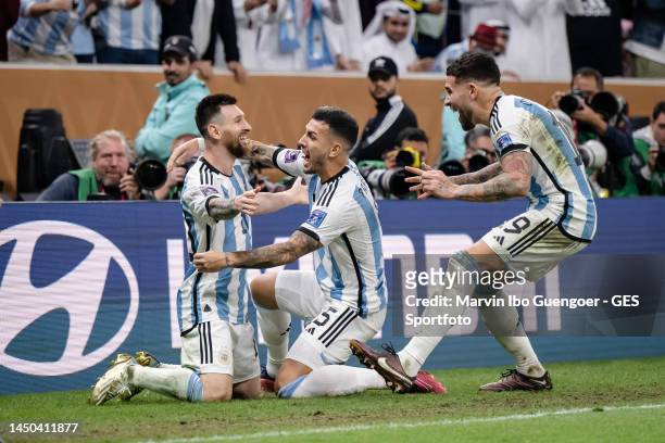 Lionel Messi of Argentina celebrates with Leandro Paredes and Nicolas Otamendi after scoring his team's third goal during the FIFA World Cup Qatar...