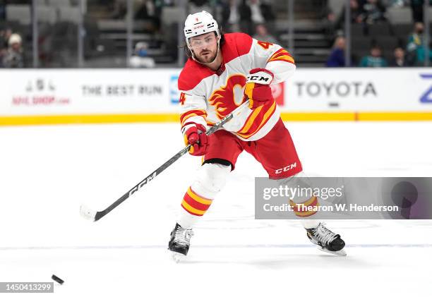 Rasmus Andersson of the Calgary Flames skates with the puck against the San Jose Sharks during the third period of an NHL hockey game at SAP Center...