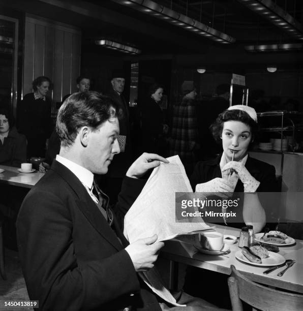 Man and woman together having lunch in the work canteen. April 1953.