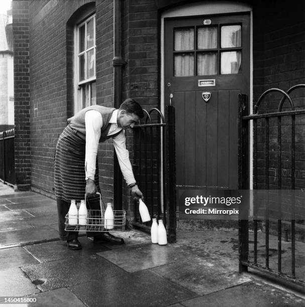 Milkman making a doorstep delivery. January 1966.