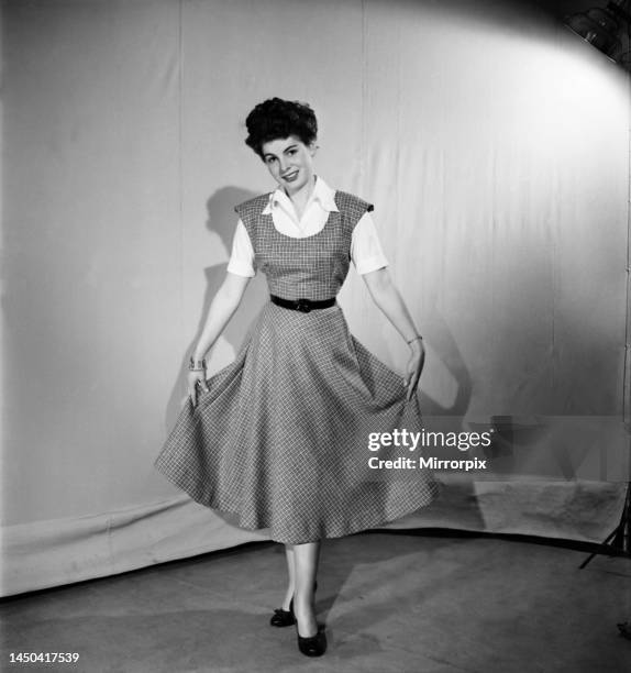 Woman wearing a pinafore dress. November 1952.