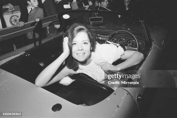 The British International Motor Show held at Earls Court, London. Actress Diana Rigg of the Avengers poses on a Lotus Elan at the show. October 1965.