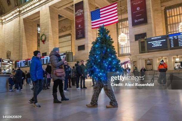 Tommy Liberto, aka Mr. Christmas Tree, from Bel Air, Maryland, walks through Grand Central Station on December 19, 2022 in New York City. Liberto is...
