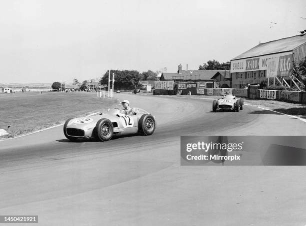 Stirling Moss leading Juan Fangio at the British Grand Prix at Aintree in Liverpool 16th July 1955.