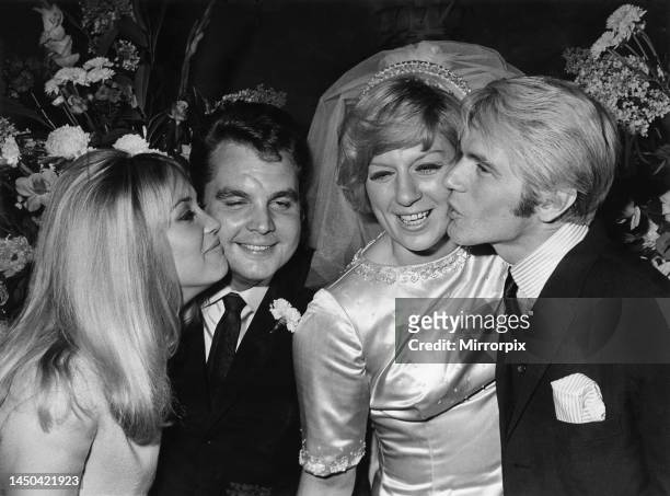 Jackie Irving kisses Tony Hatch while Adam Faith kisses Jackie Trent after the wedding. 19th August 1967.