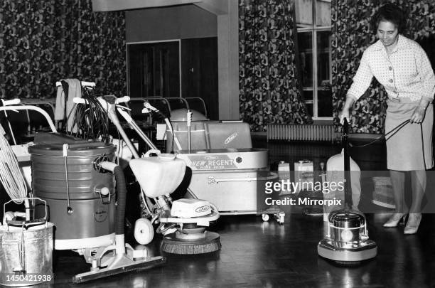 School charwoman Mrs Mabel McKennas gets her first glimpse of the automatic school cleaning equipment at Salford, Manchester. July 1966.