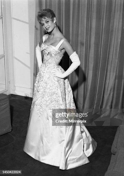 French actress Bridgitte Bardot rehearses her curtsy in anticipation of her meeting with the queen October 1956.