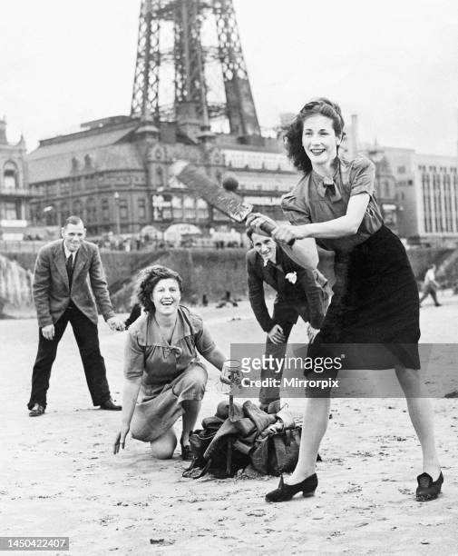 Holidaymakers play a game of cricket on the sands at Blackpool. August 1946.