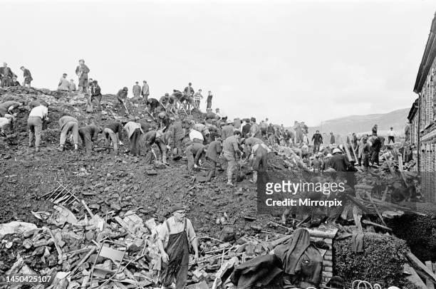 Rescuers try to find victims amongst mud and rubble at the Pantglas Junior School site. 21st October 1966.