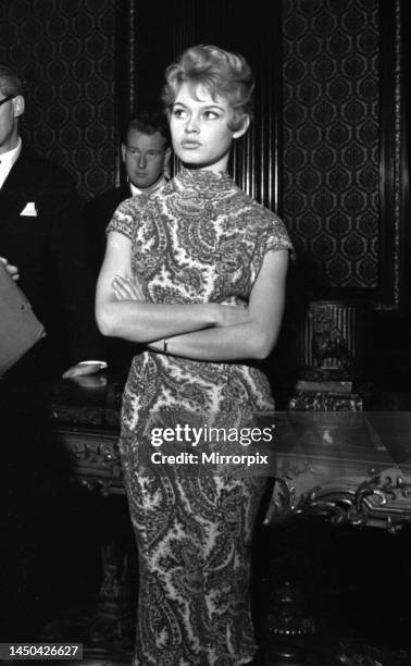 French actress Brigitte Bardot poses at the Empire Theatre, Leicester Square, London, the day before being presented to the Queen at the Royal...