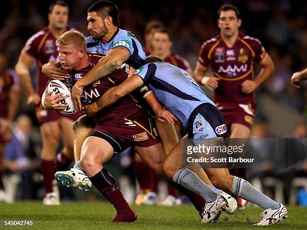Ben Hannant of the Maroons is tackled during game one of the ARL State of Origin series between the Queensland Maroons and the New South Wales Blues...