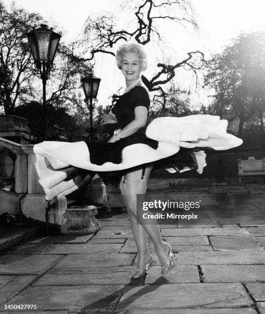 Actress Eva Gabor gives a twirl in her dressApril 1957.